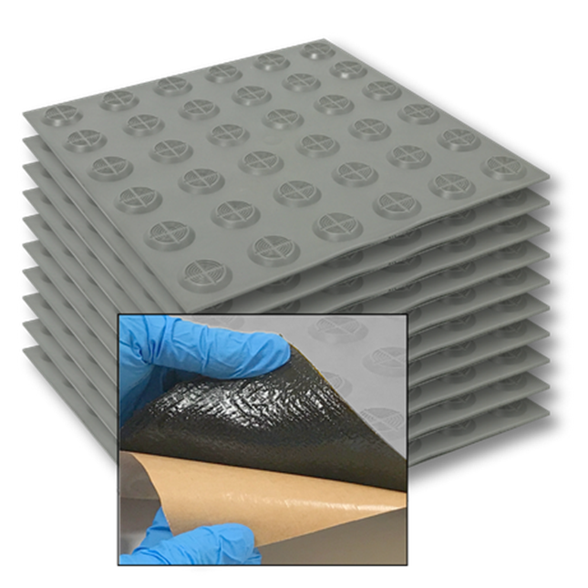 Stack of TacPro grey peel-and-stick tactile indicator tiles with popout photo of bituminous backing for context.