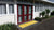 TacPro yellow peel-and-stick tactile indicator warning tiles installed on herringbone paving in front of school classroom front door