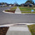 TacPro white polyurethane tactile indicator warning studs installed on lightly exposed aggregate concrete pram ramps