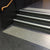 TacPro white polyurethane tactile indicator warning studs on black lino at top and bottom of stair