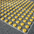 Close-up of TacPro yellow polyurethane tactile indicator warning studs on bluestone tiles